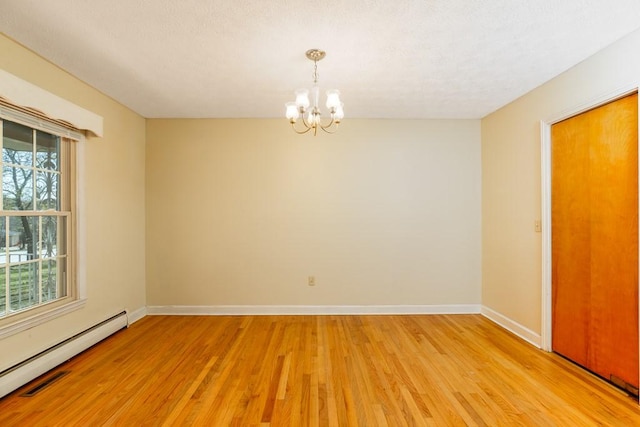 102 Norman St, Liberty, SC 29657 - unfurnished room featuring baseboards, baseboard heating, a notable chandelier, and light wood finished floors