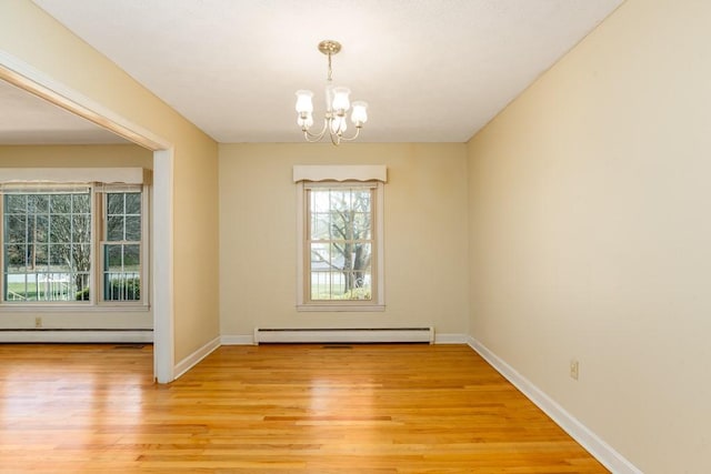 102 Norman St, Liberty, SC 29657 - empty room featuring a baseboard radiator, baseboard heating, light wood finished floors, and a chandelier
