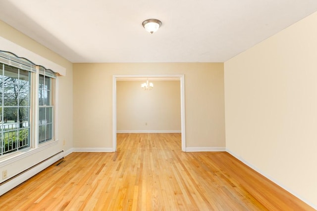 102 Norman St, Liberty, SC 29657 - empty room with an inviting chandelier, baseboards, light wood-style flooring, and baseboard heating