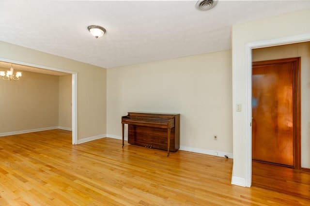 102 Norman St, Liberty, SC 29657 - empty room featuring baseboards, light wood finished floors, a chandelier, and visible vents