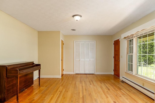102 Norman St, Liberty, SC 29657 - bedroom with baseboards, light wood-type flooring, a closet, and a baseboard heating unit