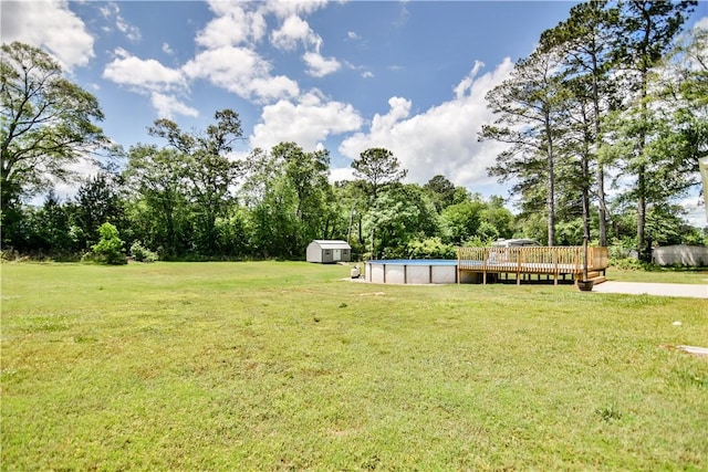 103 Mar Mac Rd, Anderson, SC 29626 - view of grassy yard with an outdoor pool, a deck, a shed, an outbuilding, and view of wooded area