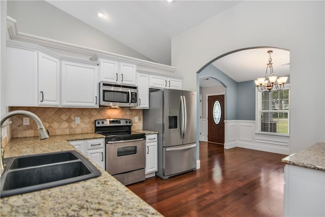 103 Mar Mac Rd, Anderson, SC 29626 - kitchen with stainless steel appliances, a sink, lofted ceiling, white cabinetry, and arched walkways