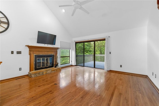 110 Safe Harbor Cir, Salem, SC 29676 - unfurnished living room featuring high vaulted ceiling, a ceiling fan, a stone fireplace, wood finished floors, and baseboards