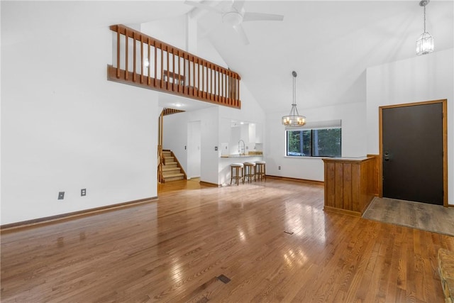 110 Safe Harbor Cir, Salem, SC 29676 - unfurnished living room featuring high vaulted ceiling, a chandelier, a sink, wood finished floors, and ceiling fan