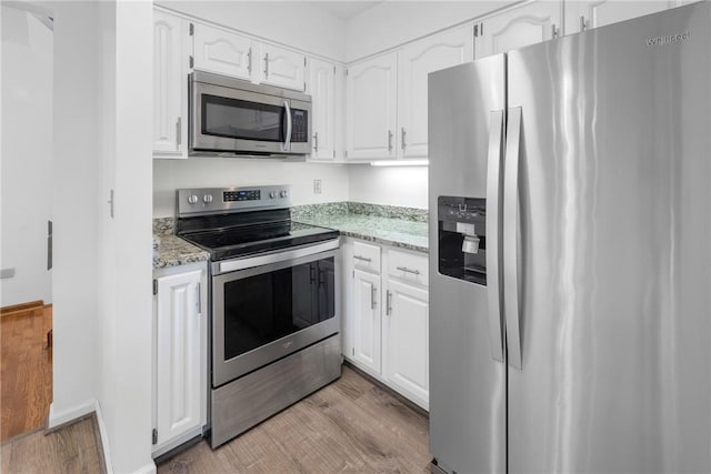 110 Safe Harbor Cir, Salem, SC 29676 - kitchen with appliances with stainless steel finishes, light wood finished floors, white cabinets, and light stone countertops
