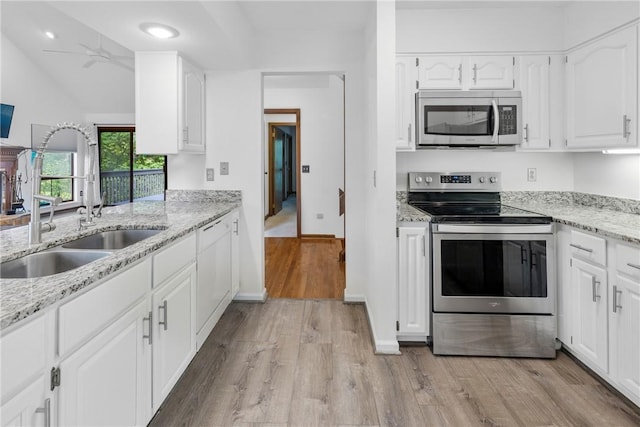 110 Safe Harbor Cir, Salem, SC 29676 - kitchen with stainless steel appliances, a sink, light wood finished floors, ceiling fan, and white cabinetry