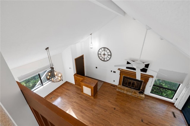 110 Safe Harbor Cir, Salem, SC 29676 - unfurnished living room with high vaulted ceiling, healthy amount of natural light, a chandelier, wood finished floors, and a glass covered fireplace