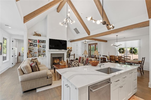 113 Settlement Village Dr, Sunset, SC 29685 - kitchen featuring stainless steel dishwasher, a sink, a chandelier, open floor plan, and beamed ceiling