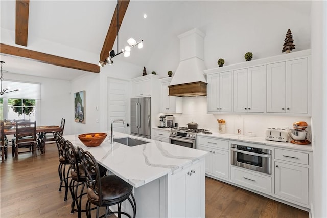 113 Settlement Village Dr, Sunset, SC 29685 - kitchen featuring a sink, stainless steel appliances, premium range hood, a center island with sink, and a chandelier