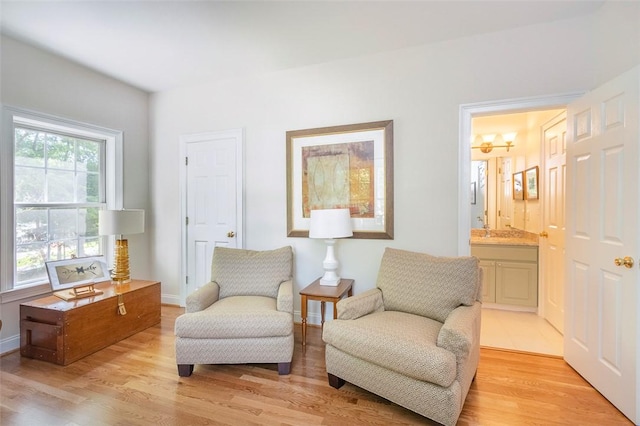 sitting room with light wood finished floors and baseboards