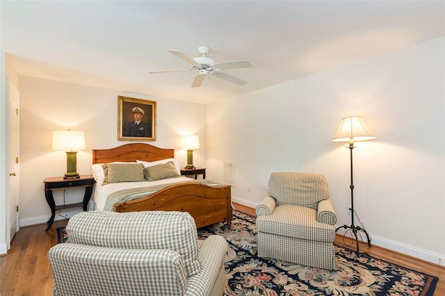 bedroom with baseboards, wood finished floors, and ceiling fan