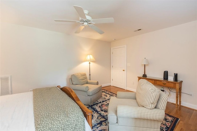 bedroom with wood finished floors, baseboards, and ceiling fan