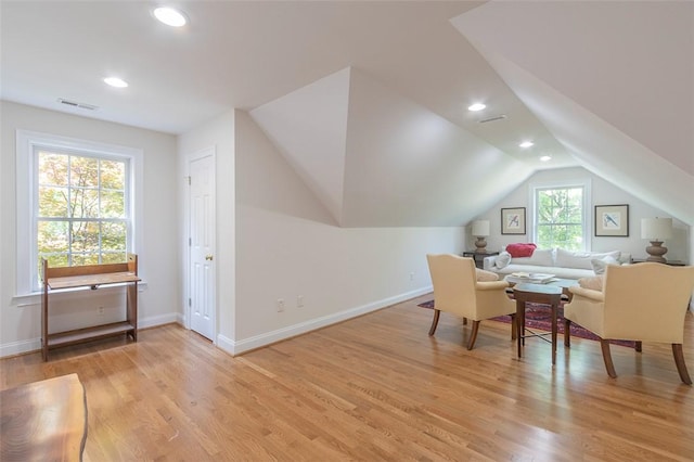 living area featuring recessed lighting, light wood-style flooring, baseboards, and lofted ceiling