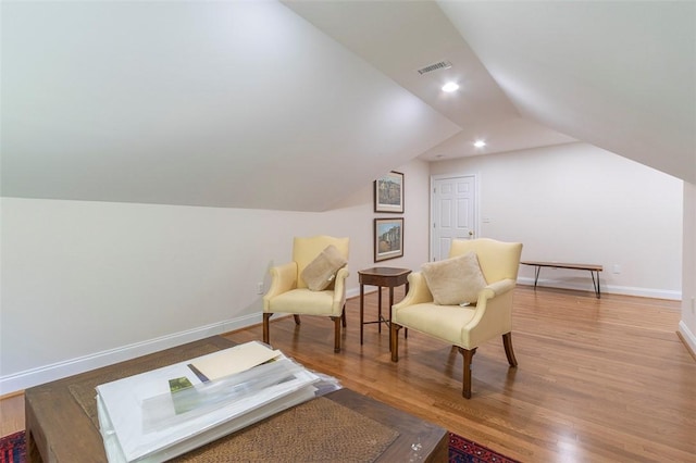 sitting room featuring lofted ceiling, wood finished floors, baseboards, and recessed lighting