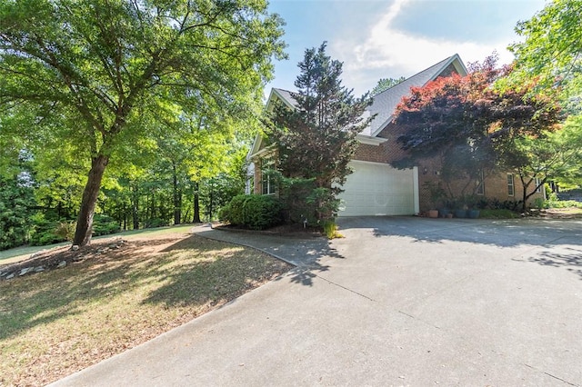 view of front of home featuring concrete driveway and a garage