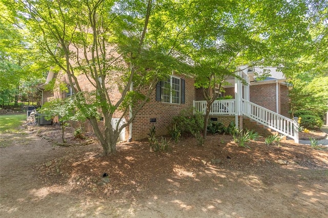 view of front facade with brick siding and crawl space