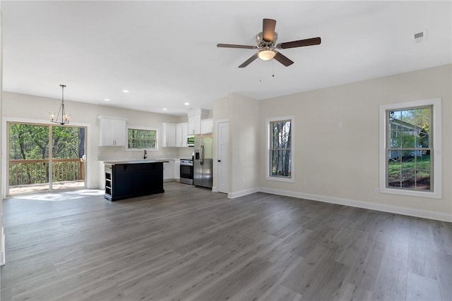 3062 Woodale Cir, Seneca, SC 29678 - unfurnished living room featuring wood finished floors, baseboards, a chandelier, and recessed lighting