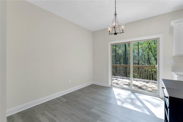 3062 Woodale Cir, Seneca, SC 29678 - unfurnished dining area with light wood-style floors, a chandelier, and baseboards