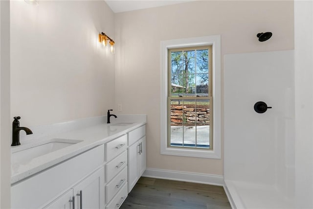 3062 Woodale Cir, Seneca, SC 29678 - full bathroom featuring wood finished floors, baseboards, double vanity, and a shower