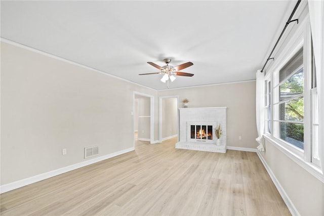 1102 Garrison Rd, Anderson, SC 29625 - unfurnished living room featuring ceiling fan, light wood finished floors, baseboards, a fireplace, and crown molding