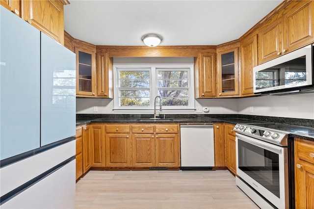 1102 Garrison Rd, Anderson, SC 29625 - kitchen with white appliances, a sink, and brown cabinets