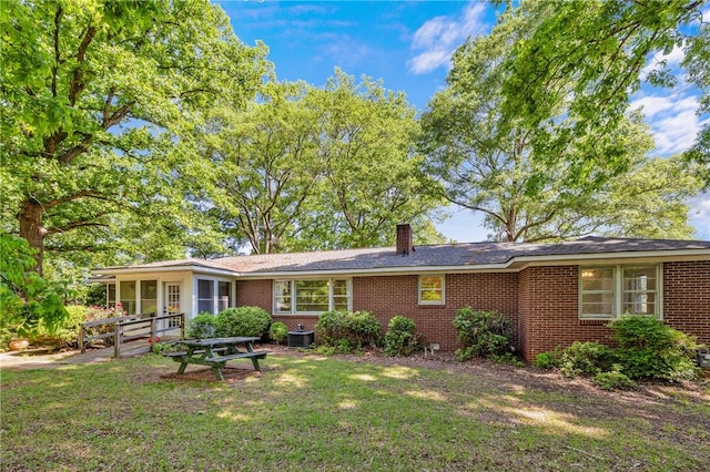 1102 Garrison Rd, Anderson, SC 29625 - rear view of house featuring brick siding, a lawn, and a chimney