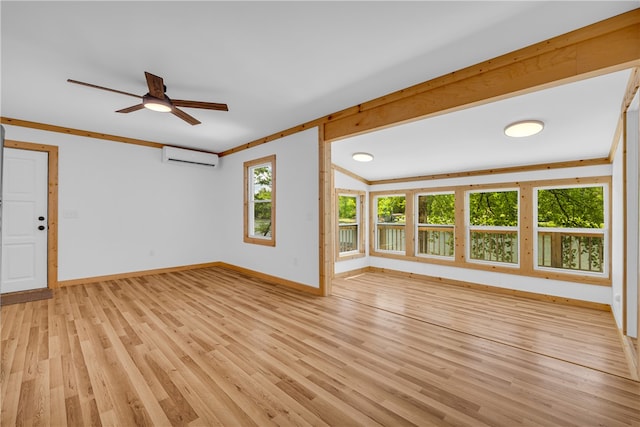 621 Crossland Creek Ct, Tamassee, SC 29686 - unfurnished living room with a wall mounted air conditioner, baseboards, light wood-style flooring, and ceiling fan