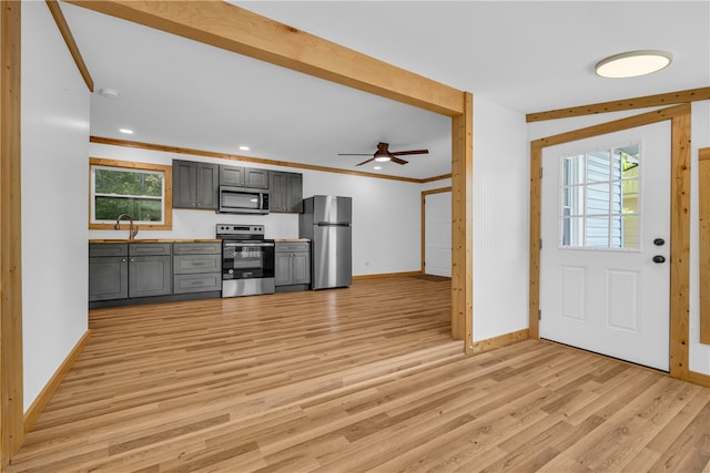 621 Crossland Creek Ct, Tamassee, SC 29686 - kitchen featuring appliances with stainless steel finishes, gray cabinets, baseboards, light wood finished floors, and ornamental molding