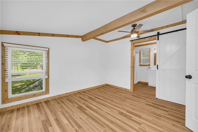 621 Crossland Creek Ct, Tamassee, SC 29686 - empty room with a barn door, light wood-type flooring, baseboards, beam ceiling, and ceiling fan