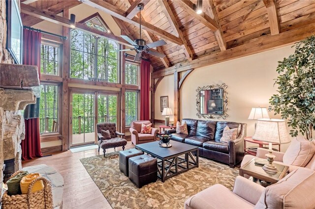 109 Laurel Pond Way, Sunset, SC 29685 - living area with high vaulted ceiling, wood ceiling, a stone fireplace, beamed ceiling, and wood-type flooring