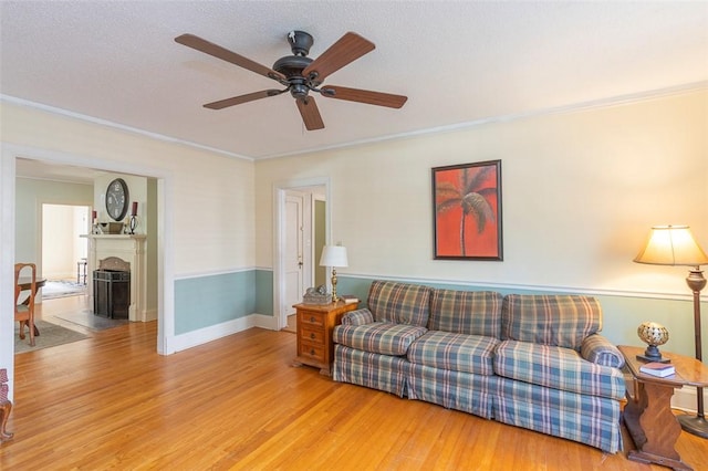 605 Boulevard, Anderson, SC 29621 - living room featuring a ceiling fan, wood finished floors, a fireplace, crown molding, and baseboards