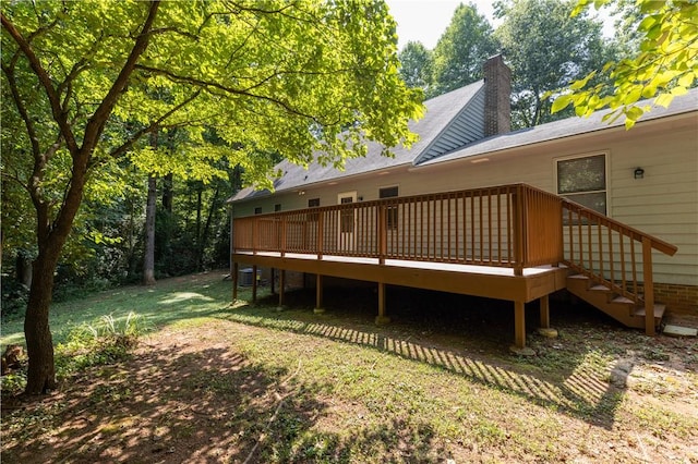 back of property with central AC, a wooden deck, and a chimney