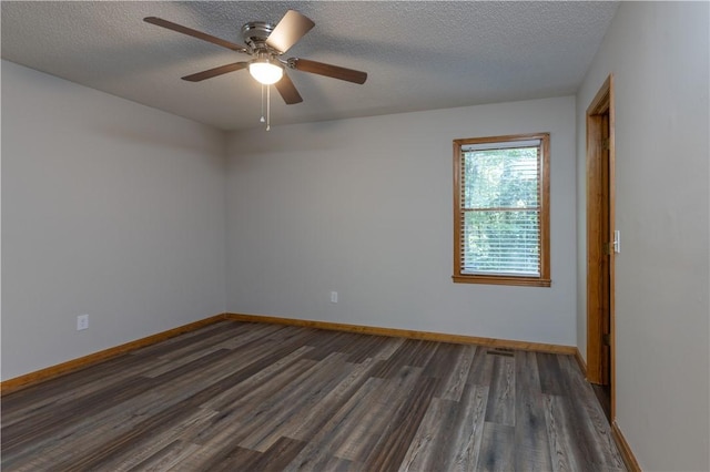 empty room featuring dark wood-type flooring, baseboards, a textured ceiling, and ceiling fan