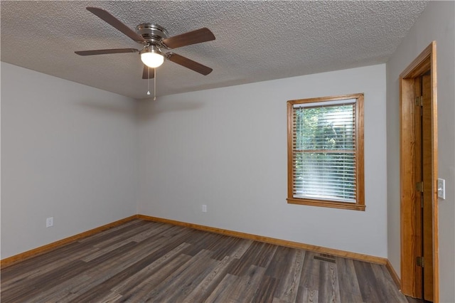 unfurnished room featuring dark wood finished floors, baseboards, ceiling fan, and a textured ceiling
