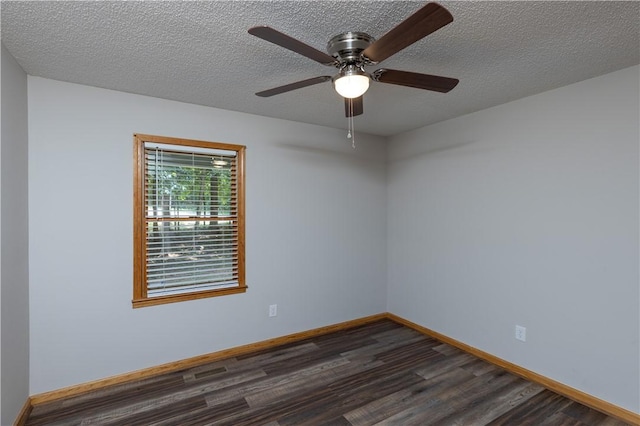 empty room featuring dark wood-style flooring, ceiling fan, baseboards, and a textured ceiling