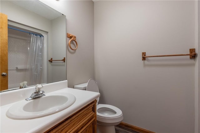 bathroom featuring toilet, vanity, a shower with shower curtain, and wood finished floors