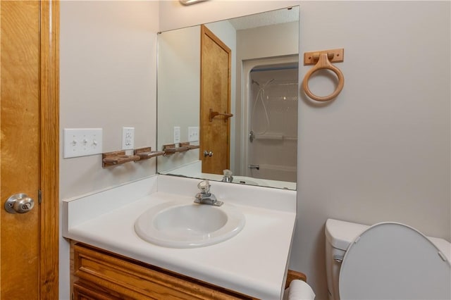 full bath featuring toilet, vanity, and a shower