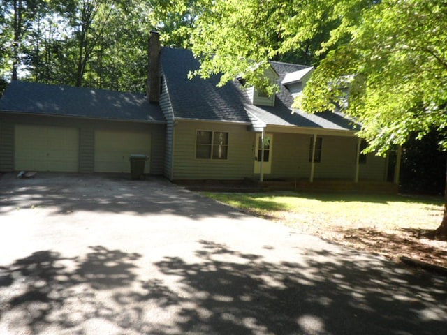 124 S Spring St, Central, SC 29630 - view of home's exterior with a garage and asphalt driveway