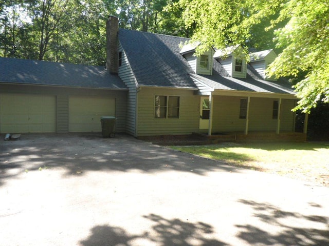 124 S Spring St, Central, SC 29630 - view of front of house with an attached garage, a chimney, and asphalt driveway