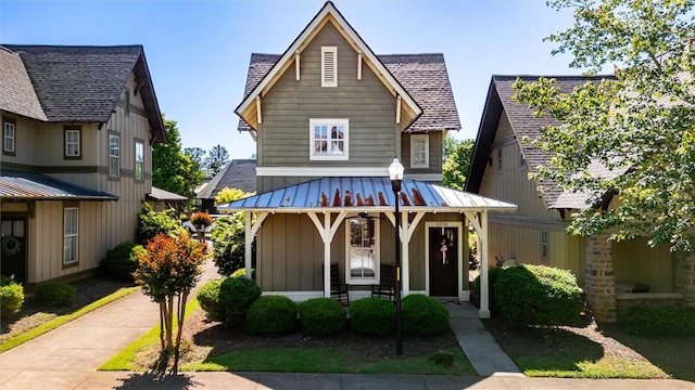 view of front of property featuring board and batten siding, a porch, a standing seam roof, metal roof, and a shingled roof
