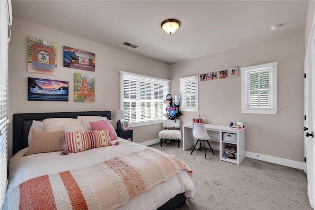 carpeted bedroom featuring baseboards