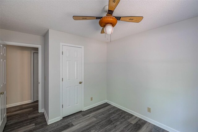 1012 Kens Pl, Taylors, SC 29687 - unfurnished bedroom featuring dark wood-type flooring, baseboards, a textured ceiling, and ceiling fan