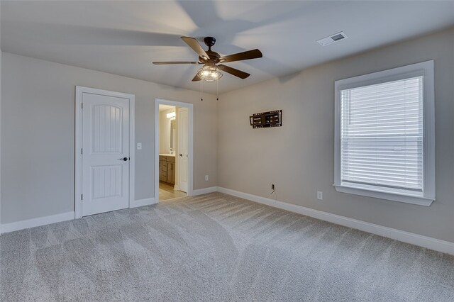 709 Whitemarsh Ave, Simpsonville, SC 29680 - unfurnished bedroom featuring light carpet, baseboards, ensuite bath, and a ceiling fan