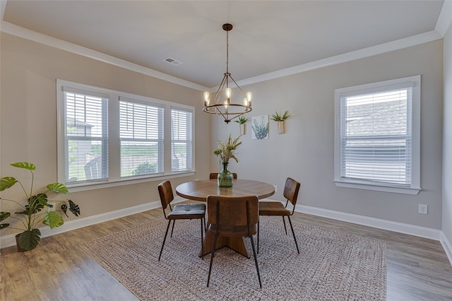709 Whitemarsh Ave, Simpsonville, SC 29680 - dining room with a chandelier, wood finished floors, baseboards, and crown molding