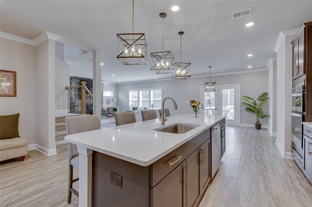 709 Whitemarsh Ave, Simpsonville, SC 29680 - kitchen with a sink, open floor plan, stainless steel appliances, light wood-style flooring, and crown molding