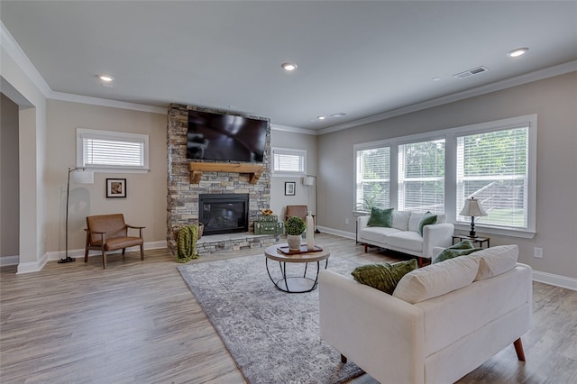 709 Whitemarsh Ave, Simpsonville, SC 29680 - living area with plenty of natural light, wood finished floors, baseboards, ornamental molding, and a stone fireplace
