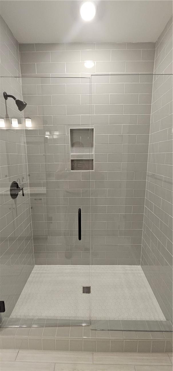 full bath with a shower stall