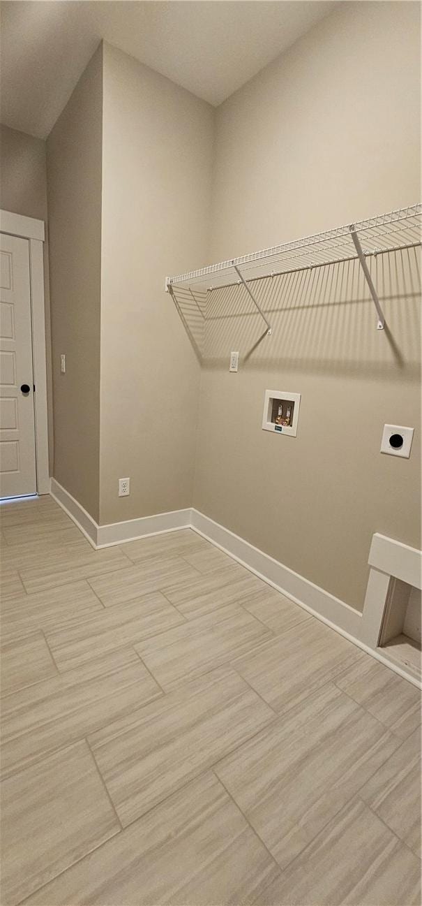 washroom featuring hookup for an electric dryer, washer hookup, and baseboards