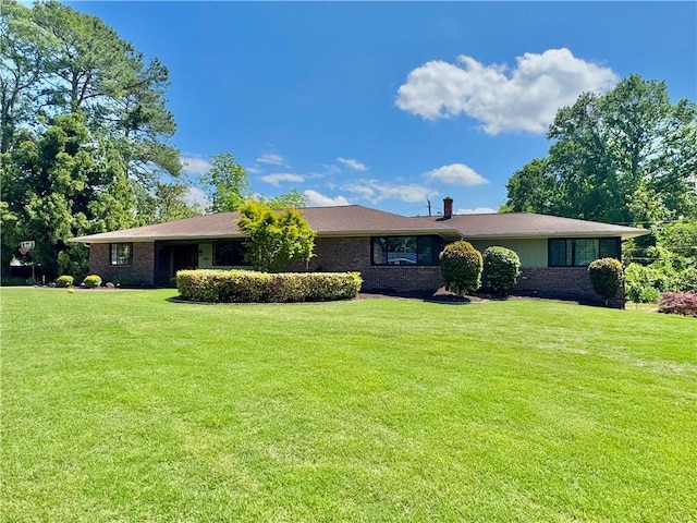 single story home with a front yard and brick siding
